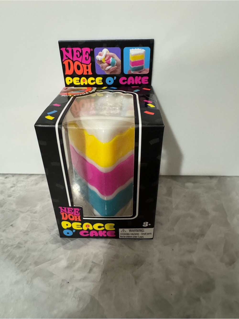Nee Doh Peace O' Cake Squeeze Toy - White, Yellow, Pink, Blue
